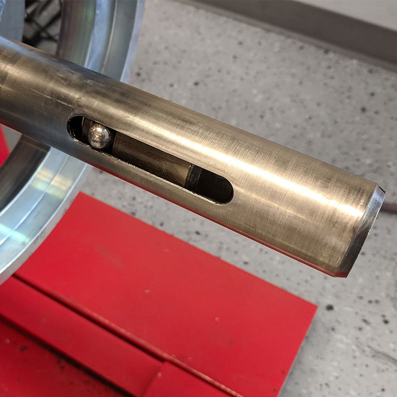 a metal object on a red surface