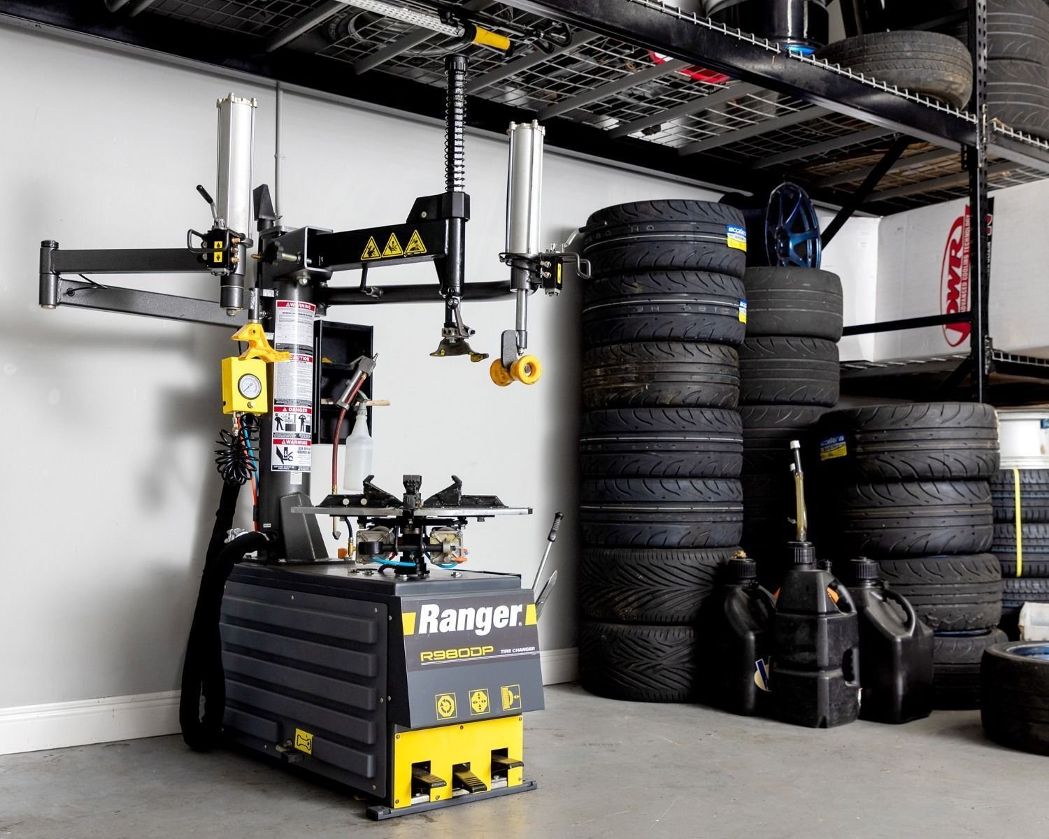 Ranger R980DP tire changer with dual assist towers used in a tire shop
